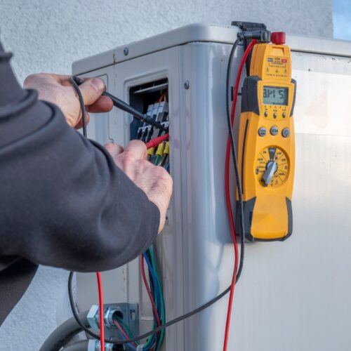 hands testing voltage with test leads at power terminals remlap al